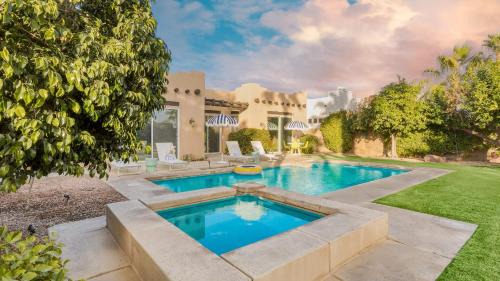 Bermuda Dunes House | Pool Hot Tub Yard Games Chic Midcentury Design Painted Sand by AvantStay