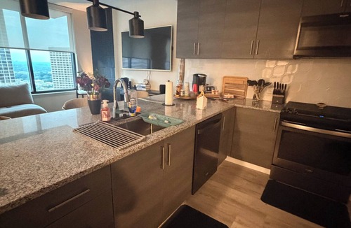Peachtree Center Apartment | Cozy 2-bedroom High-Rise apt in Downtown Atlanta w/pool, gym, & rooftop access.